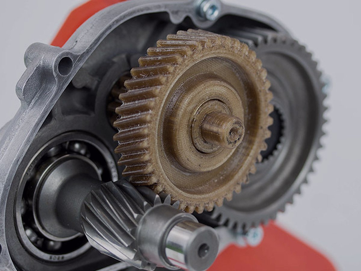A printed nylon gear running in a gearbox