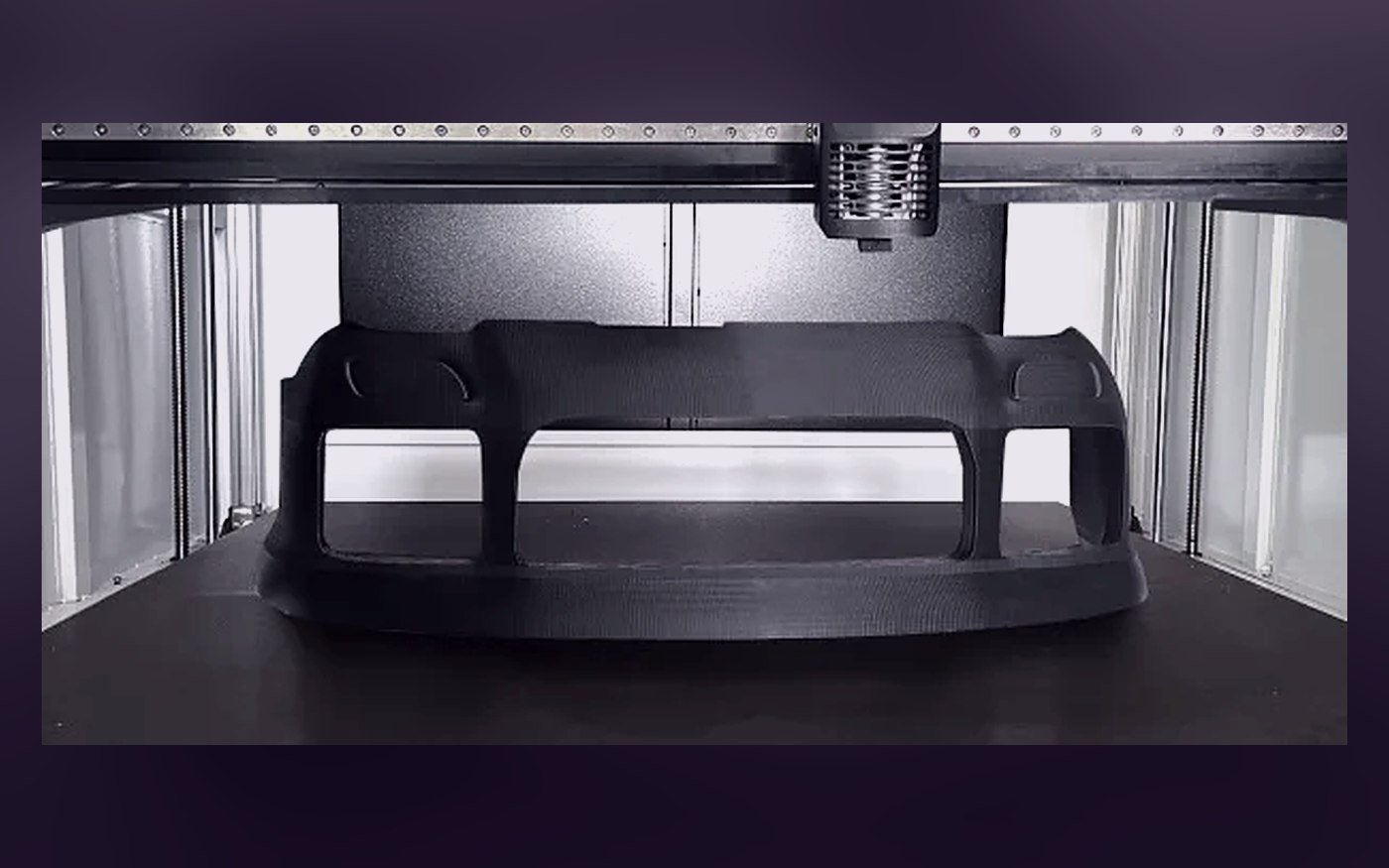A full-width car bumper printing on a large-format bed