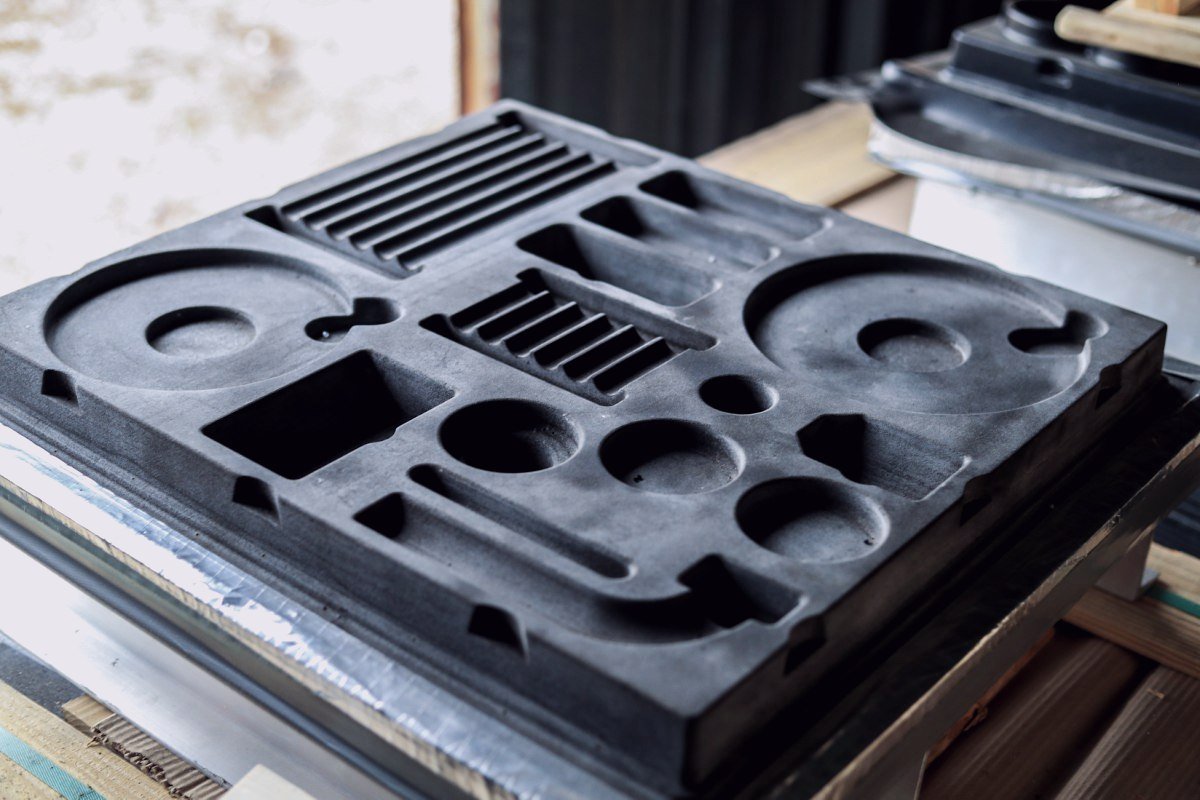 A printed mould tool with machined cavities